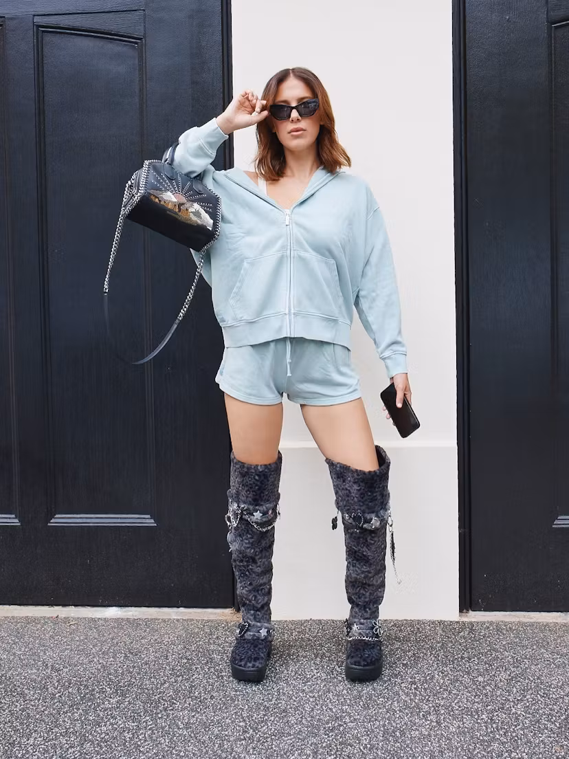 Millie Bobby Brown wears a sweat set and fur boots.  