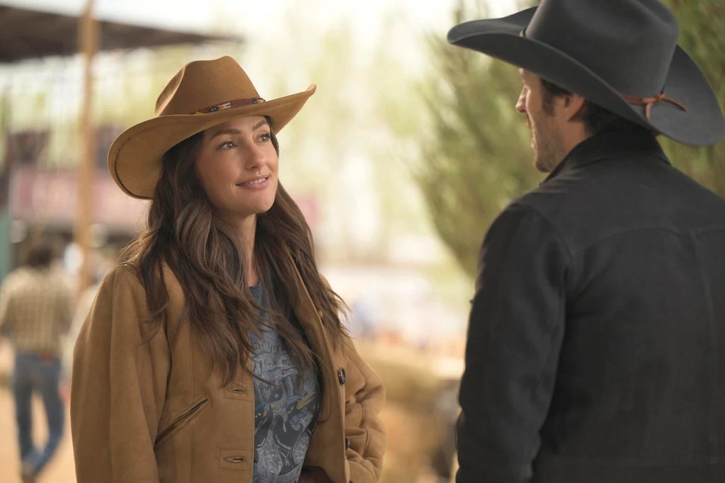 woman in hat and matching jacket looking at man