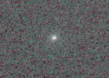Comet 3I/ATLAS is feasible as a bright point of glowing light in the center of a pixelated black and dark grey background.
