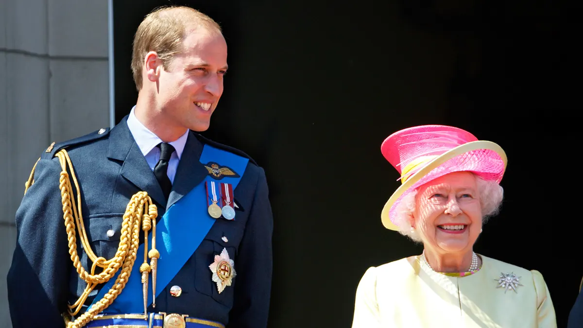 Prince William and Queen Elizabeth smiling on the balcony of Buckingham Palace.