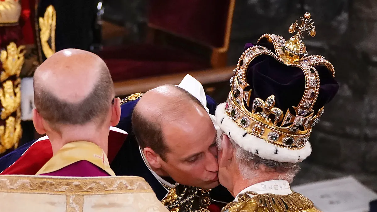 Prince William kissing King Charles on the cheek during the monarch's coronation.