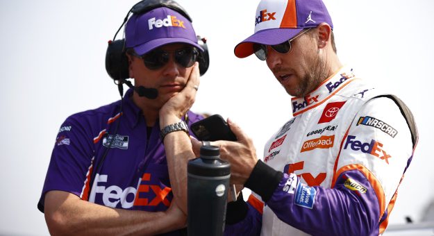 ELKHART LAKE, WISCONSIN - JULY 04: Denny Hamlin, driver of the #11 FedEx Freight Toyota, and crew chief Christopher Gabehart talk on the grid during qualifying for the NASCAR Cup Series Jockey Made in America 250 Presented by Kwik Trip at Road America on July 04, 2021 in Elkhart Lake, Wisconsin. (Photo by Jared C. Tilton/Getty Images) | Getty Images