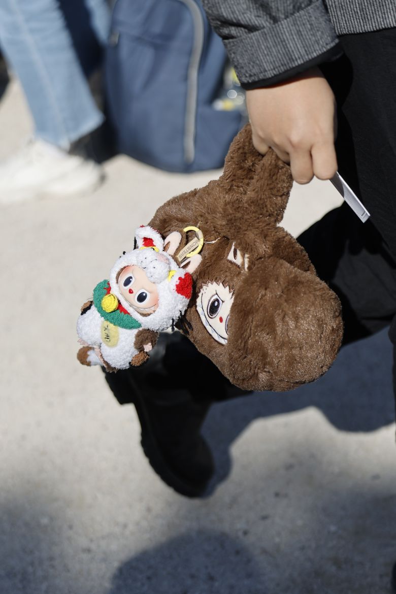 A guest wears brown fur Labubu bag with Labubu charm attached, outside Dior, during the Womenswear Spring Summer 2026 as part of Paris Fashion Week in Paris, France, on October 1, 2025.