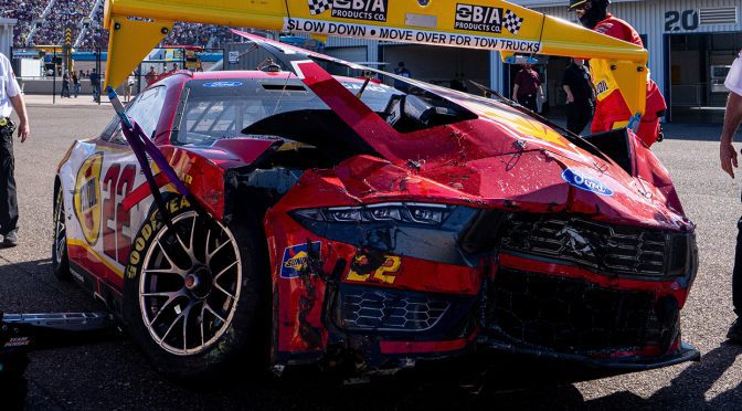 Logano wrecks after contact with Allmendinger