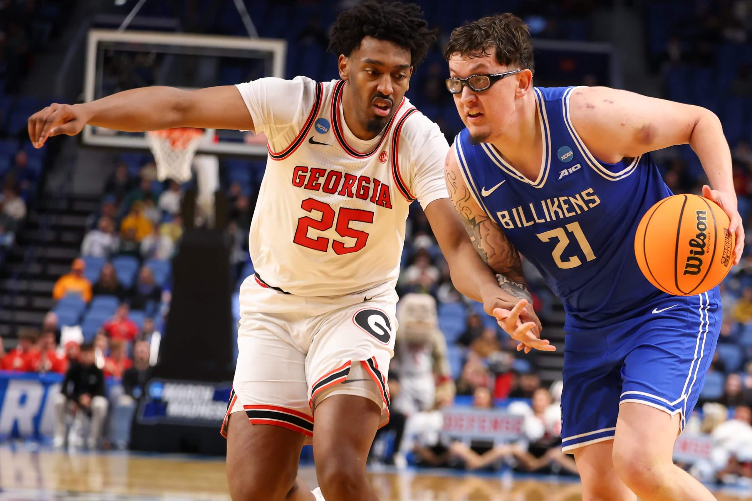 Robbie Avila dribbles the ball with his left hand as a Georgia defender reaches in